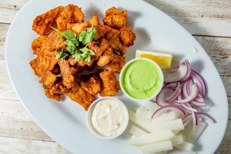 <who>Photo Credit: Contributed</who>Fish pakora with Garcha Bros’ signature green and white sauces.