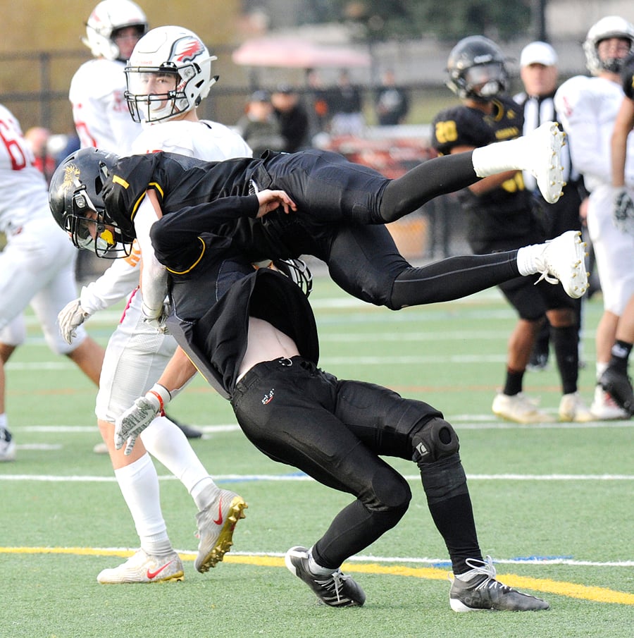 <who>Photo Credit: Lorne White/KelownaNow </who>Isaac Athans, top, and Nathan Gilbert collide while trying to pick off a Carson Graham pass in the second quarter.