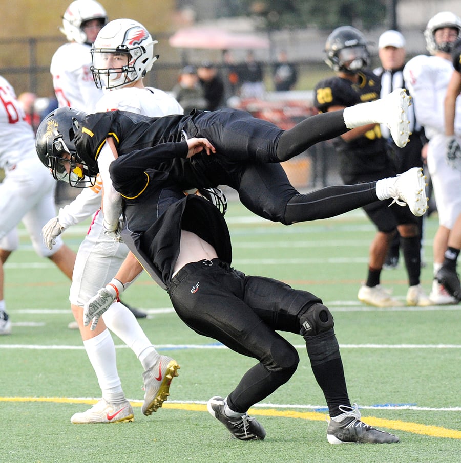 Isaac Athans, top, and Nathan Gilbert collide while trying to pick off a Carson Graham pass in the second quarter.
