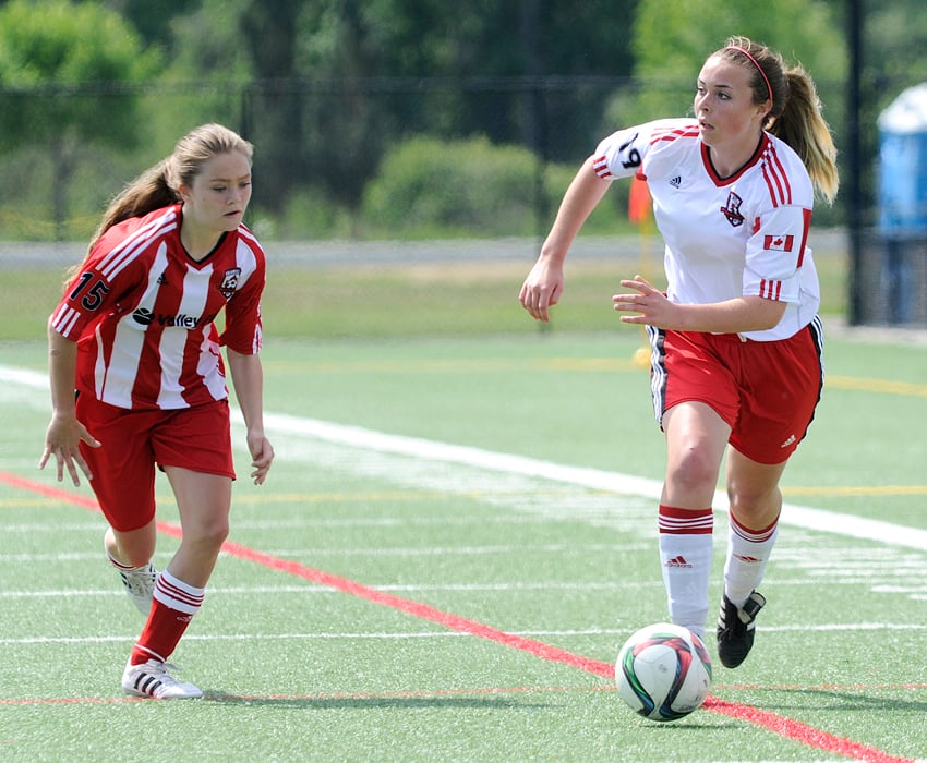 <who>Photo Credit: Lorne White/KelownaNow </who>Madison Robertson, right, of the United U16s streaks down the wing looking for a teammate to pass to while U15s' Tiernan Hickson defends.
