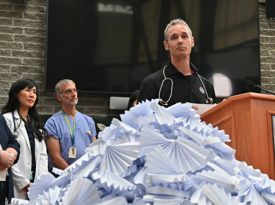 <who> Photo credit: LJI </who> Paramedic David Hollingworth talks about responding to cardiac arrests during the 2021 heat dome, which killed more than 619 British Columbians. Each person killed is represented by a white fan.