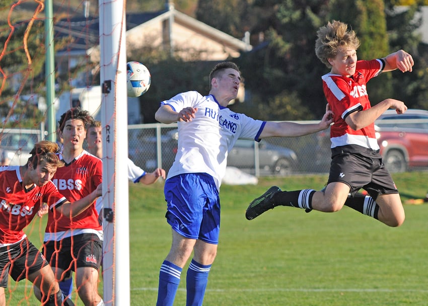 <who>Photo Credit: Lorne White/KelownaNow </who>Shawn Kostiuk, right, in mid-air after heading the ball toward the Rutland net. The other Boucherie Bears are, from left, Nemanja Vracerevic and Brennan Martin. Defending is Edvin Holok of the Voodoos.