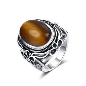 Anello in argento con occhio di tigre e intarsio di fiori.