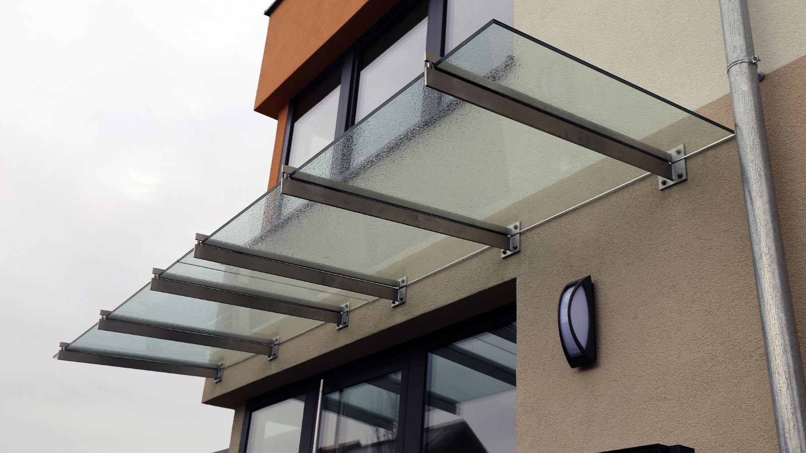 What is the difference between a patio cover and an awning?
