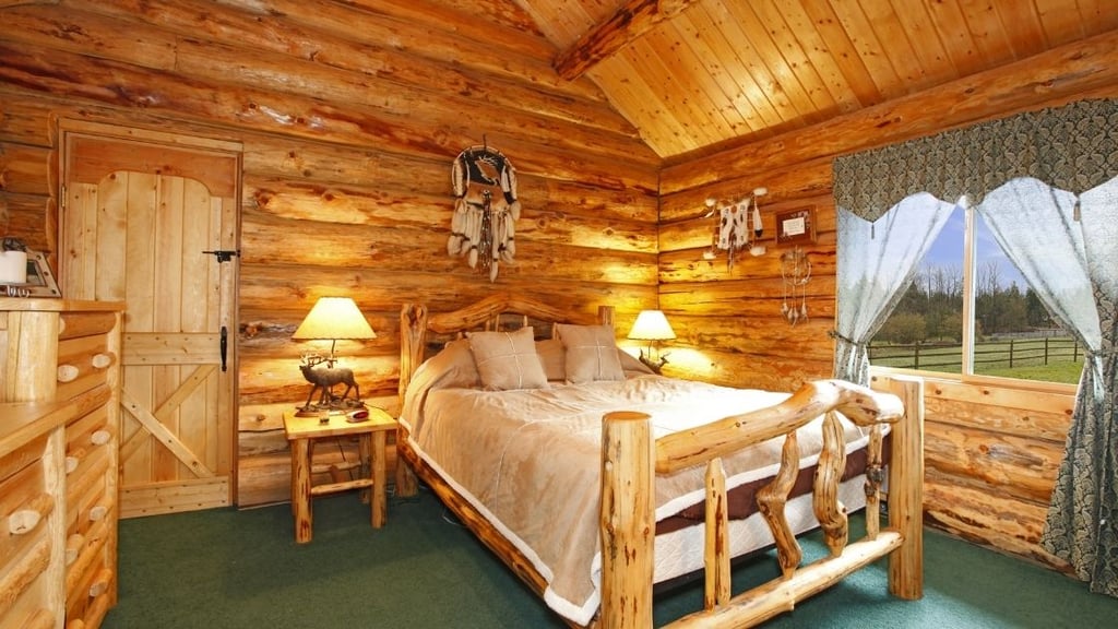 Here we have another tremendous wooden bed.  This room looks like something out of a fairy tale.  Everything is slightly irregularly shaped from the bed to the bedside tables and dresser.
