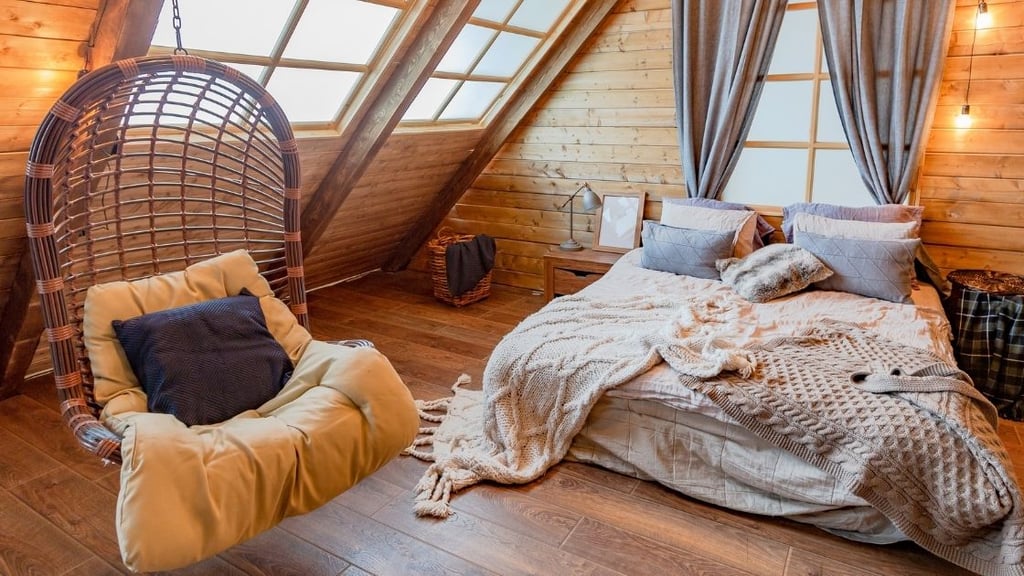 This attic room is full of natural light bouncing off the wooden walls and floor.  The lights and the floating chair remind me of the attic of an old barn.  This space would be a fantastic room for a romantic weekend.
