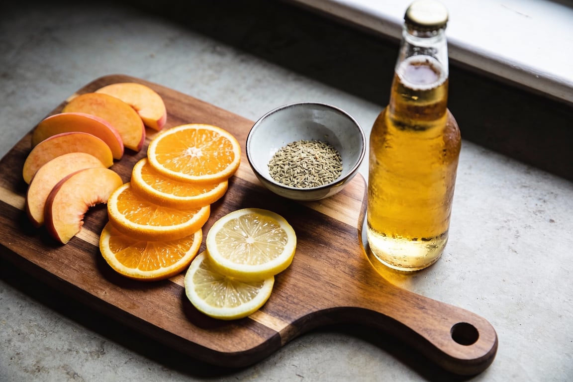Pouring a Belgian Witbier cocktail using the gentle fold technique to maintain foam