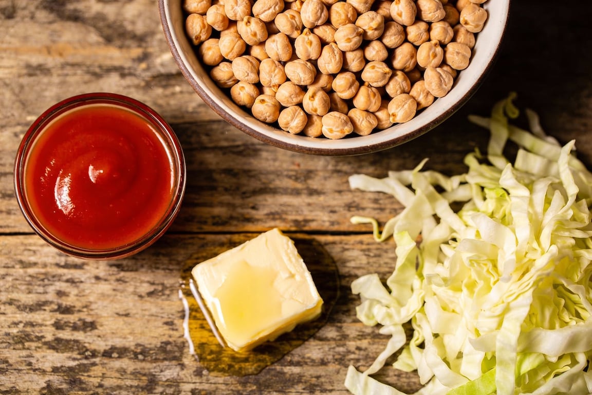 Searing chickpeas in a skillet for the Buffalo Chickpea Wrap