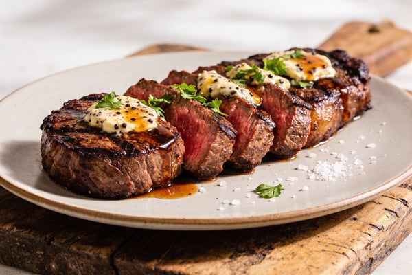 Grilled Manhattan-Style Strip Steaks with Bourbon-Peppercorn Butter