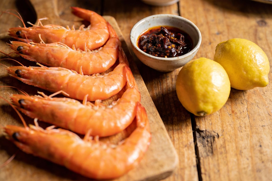Charred lemon prawns being seared over direct heat