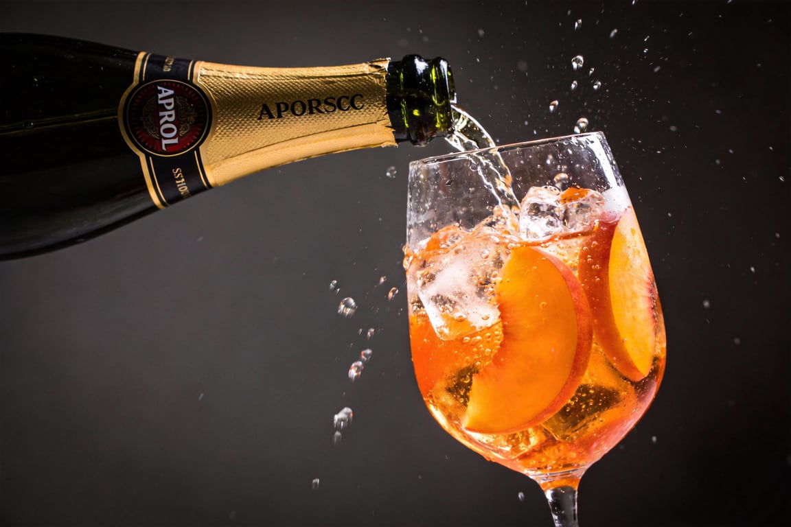 Applying the basil smack to a peach cocktail garnish