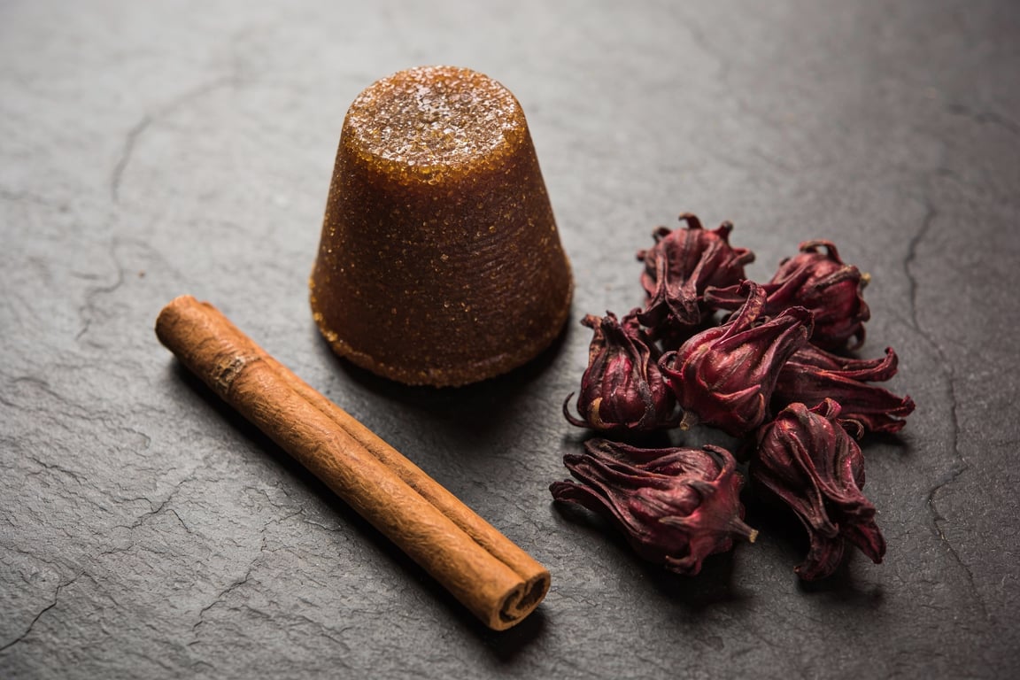 Hibiscus flowers simmering with piloncillo and cinnamon stick