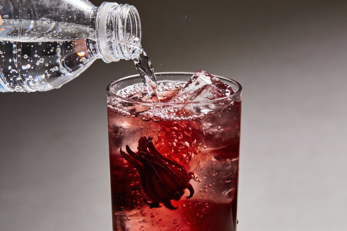 Refreshing Sparkling Agua de Jamaica in a tall glass with lime and ice