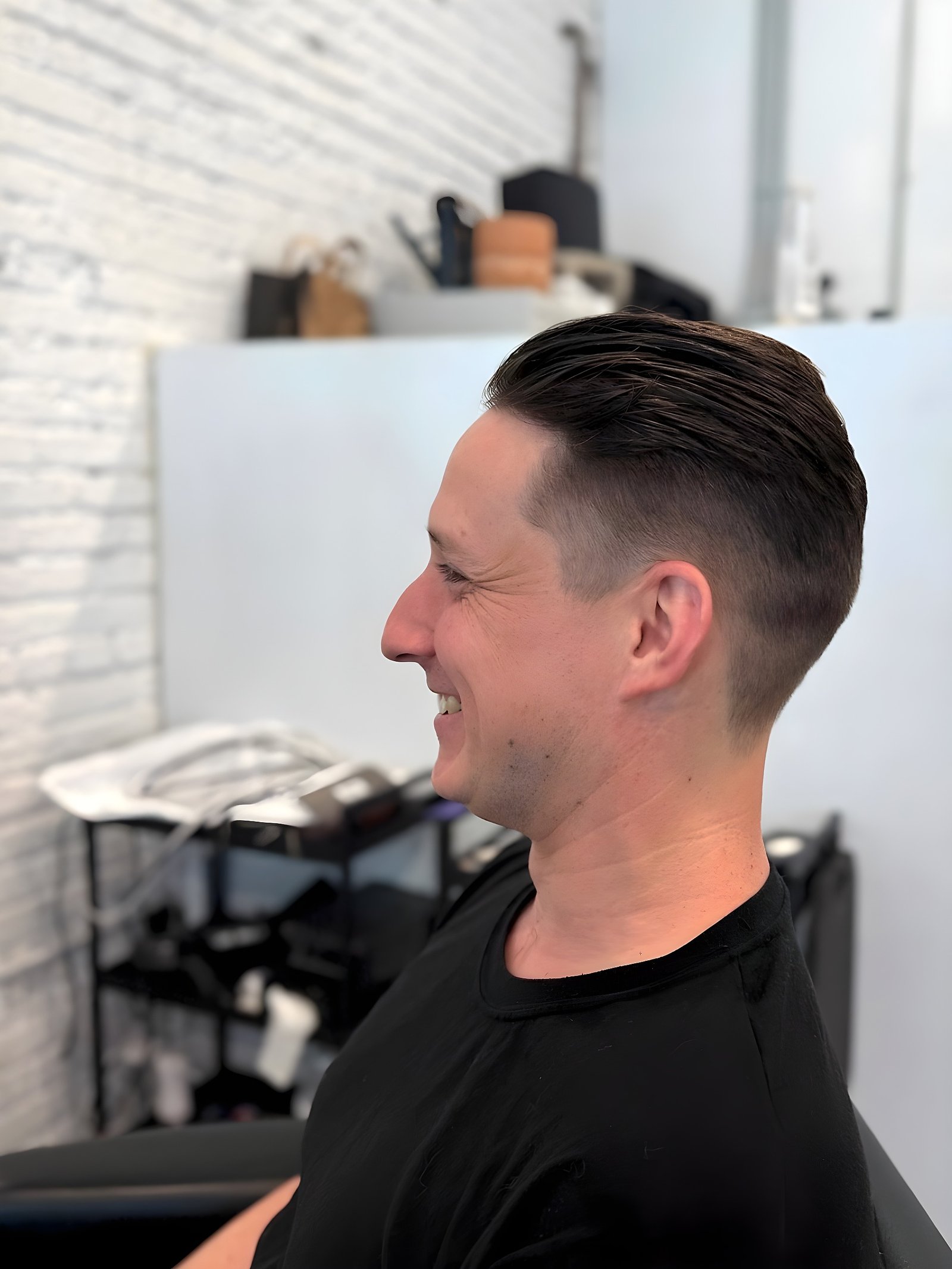 Classic slicked-back hairstyle with a tapered fade.