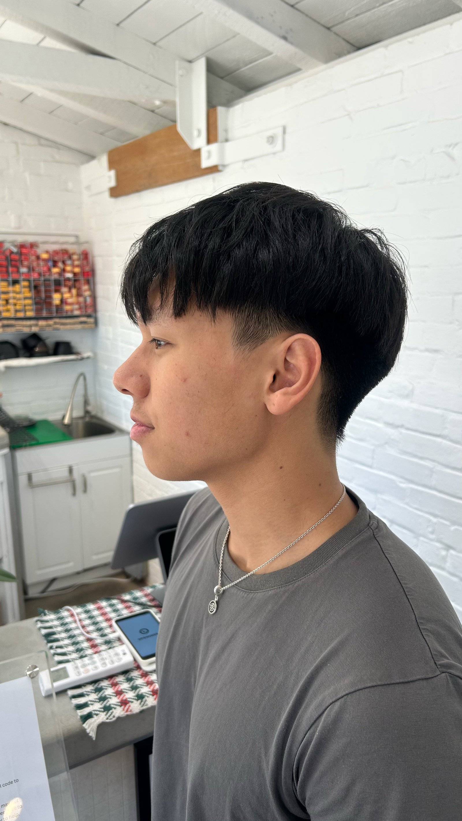 Clean textured haircut with a subtle fade and natural finish.