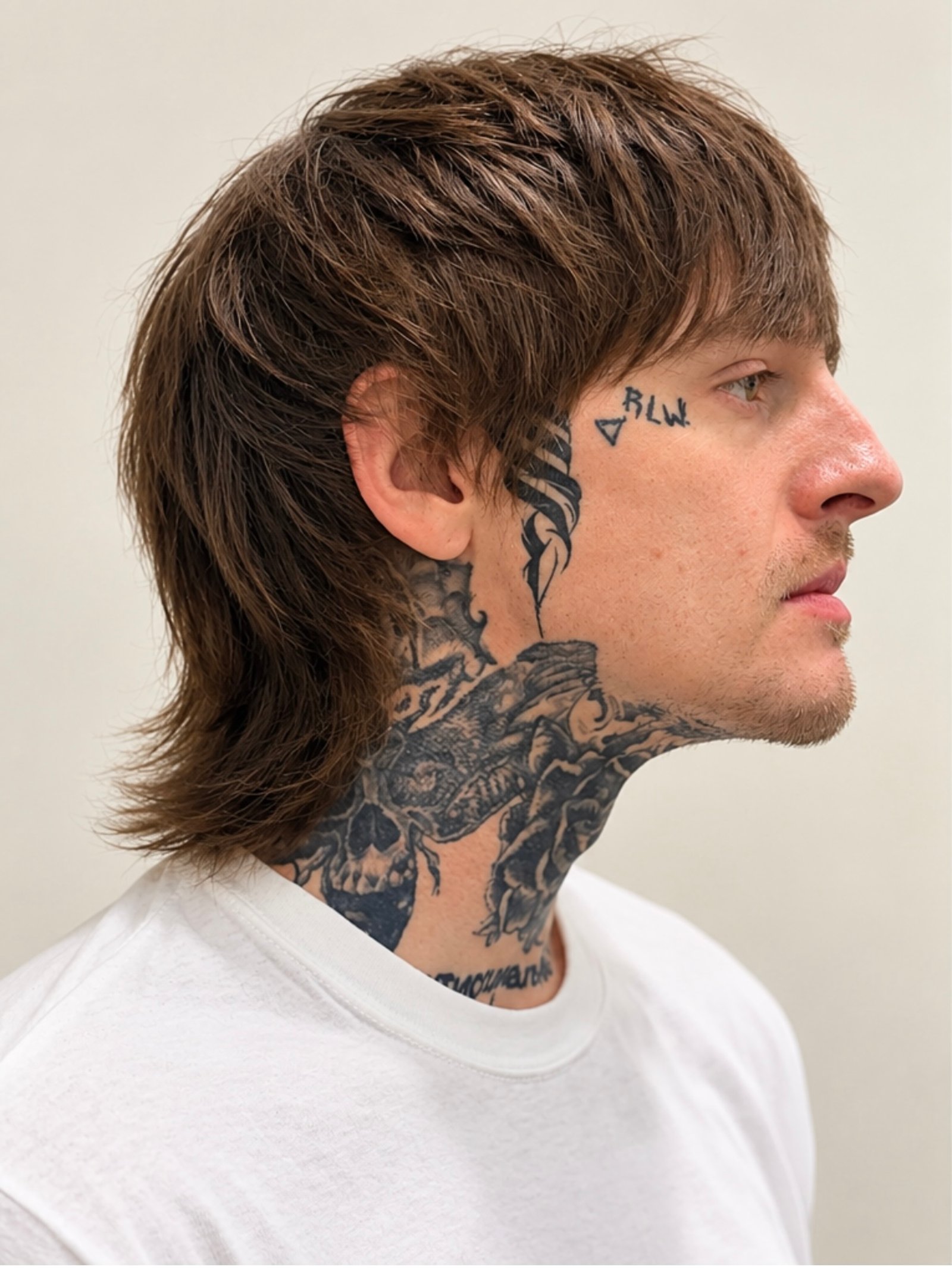 Layered haircut with a textured finish and visible tattoos.