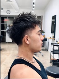 Textured hairstyle with a clean fade and defined shape.