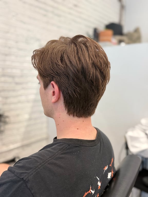 Stylish layered haircut with natural movement and texture.