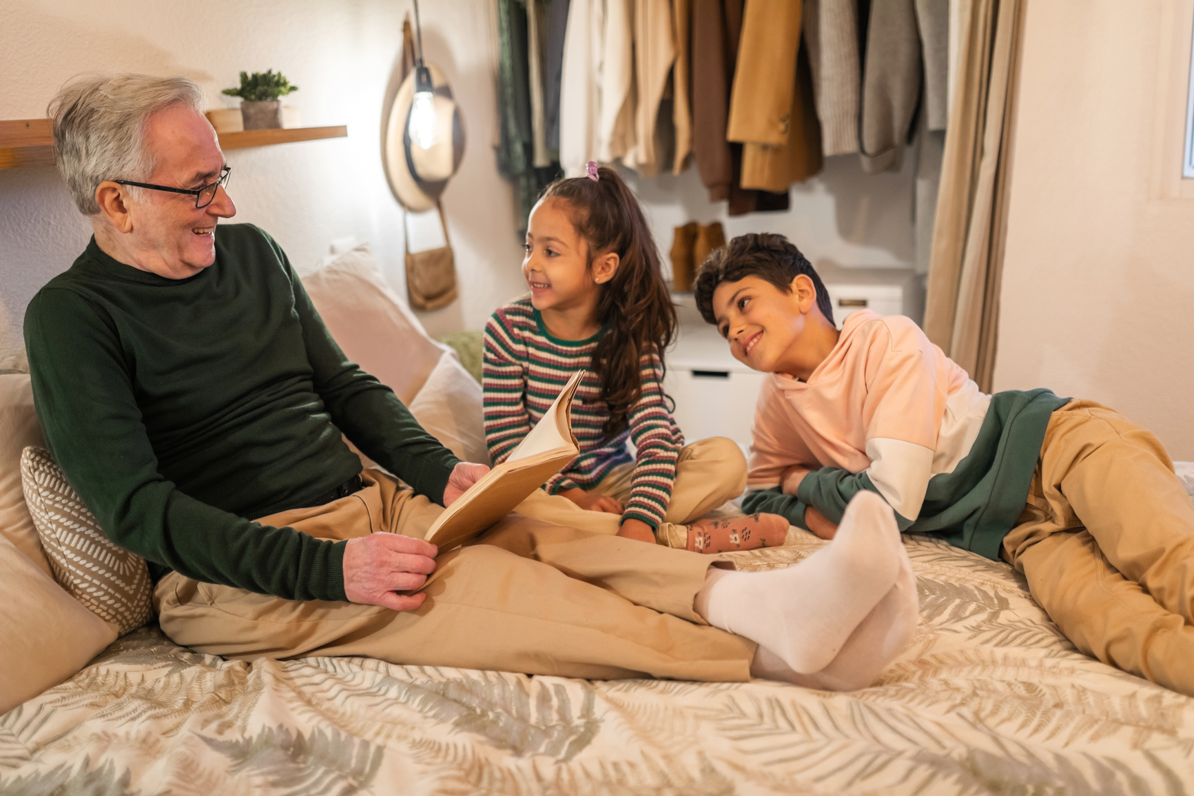 Grandparent reading a book to grandchildren.