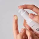 Applying Beauty of Joseon Ginseng Sun Serum on back of hand - no white cast