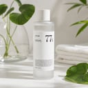 Anua Heartleaf 77 Soothing Toner on vanity with calming skincare routine