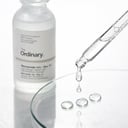 The Ordinary Niacinamide Zinc Serum clear droplets on glass surface