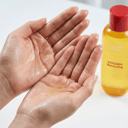 Applying Eqqualberry Vitamin C toner - dewy texture on hands