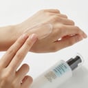 Applying COSRX Oil-Free Birch Sap Lotion on back of hand - lightweight texture