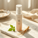 Beauty of Joseon Ginseng Sun Serum on marble surface with ginseng root