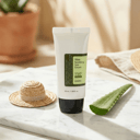 COSRX Aloe Soothing Sun Cream on marble surface with aloe leaf