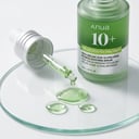 ANUA Azelaic Acid Serum green silky droplets on glass surface