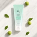 Beauty of Joseon Green Plum Cleanser on surface with plum and botanical elements