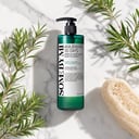 Some By Mi Acne Body Cleanser on surface with tea tree elements