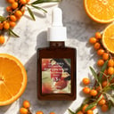 Dr Althea Vitamin C Boosting Serum on surface with citrus elements