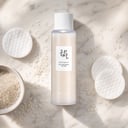 Beauty of Joseon Rice Milk on surface with rice grains and cotton pads
