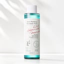 Axis-Y Daily Purifying Treatment Toner on vanity with skincare routine