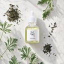 Beauty of Joseon Calming Serum on surface with green tea and botanical elements