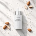 Tirtir Ceramic Milk Ampoule on surface with dropper
