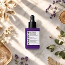 Some By Mi Retinol Intense Serum on surface with botanical elements