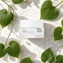 Anua Heartleaf 70 Calming Cream on surface with green botanical elements