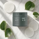 Anua Heartleaf 77 Clear Pad jar with individual pad on surface