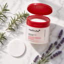 Medicube Red Succinic Acid Peeling Pads jar with individual pads on surface