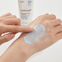 Applying Medicube Zero Pore Sun Serum on back of hand - lightweight no white cast