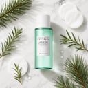 Skin1004 Tea-Trica Purifying Toner on surface with tea tree and cotton pads
