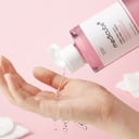 Applying Medicube PDRN Pink Cica Toner with cotton pad on hand