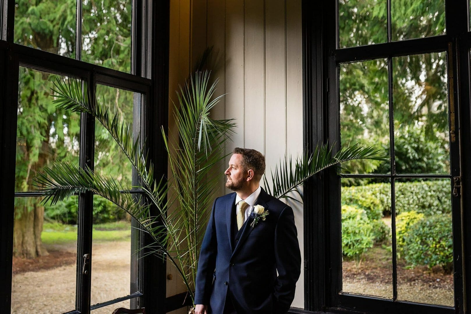 Groom awaits the bride at Larmer tree Gardens