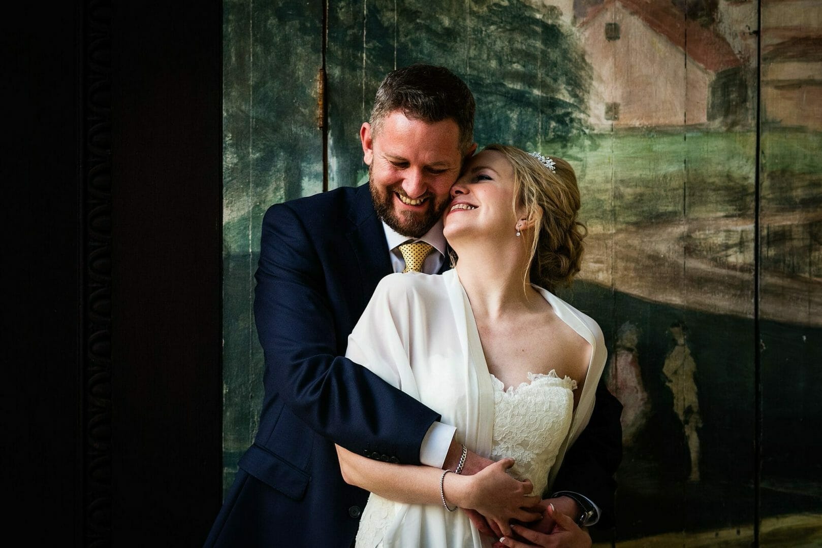 Bride and Groom by the Mural at the Larmertree gardens