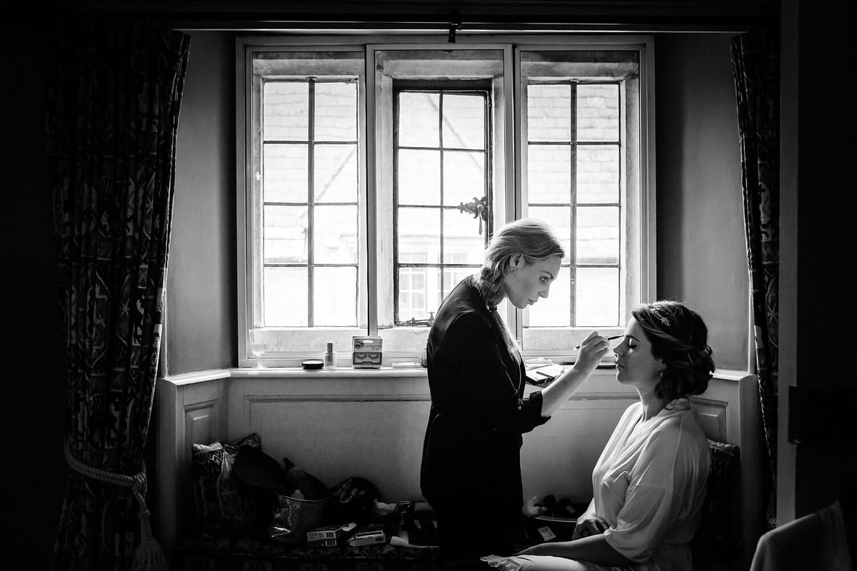 Bride and makeup artist in Window