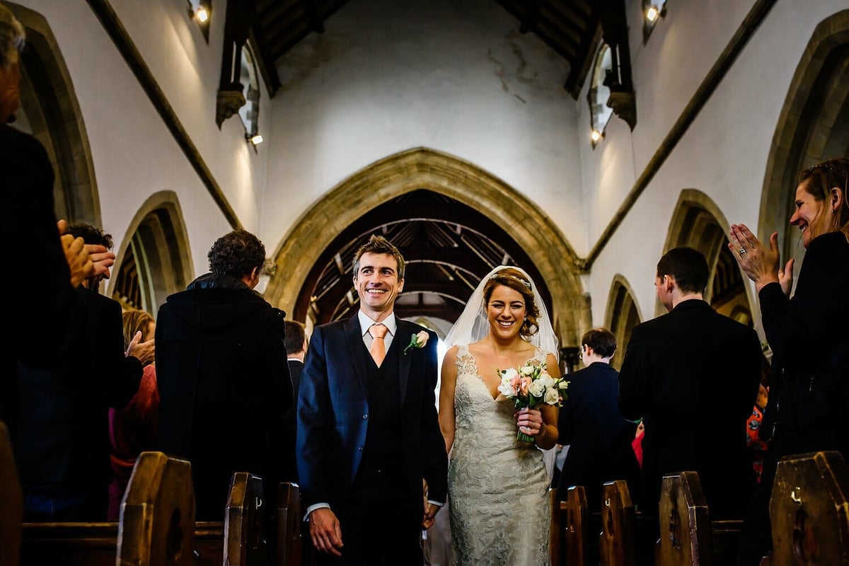 Bride and Groom walk out of St Edwards