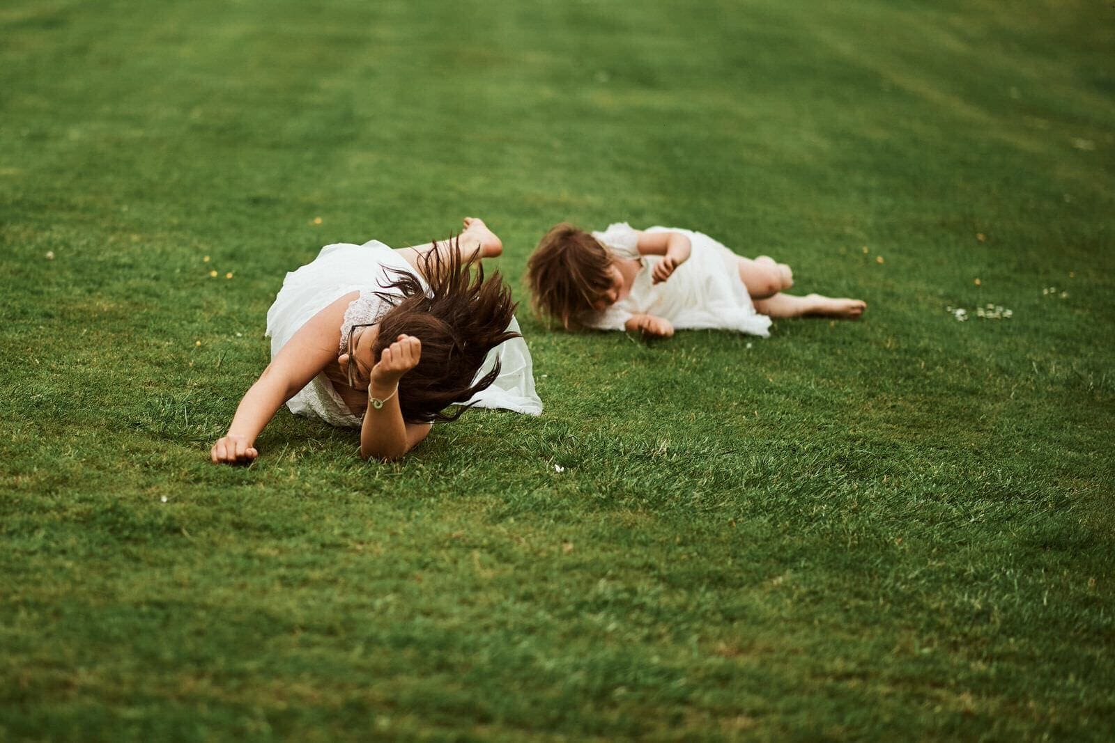 Flowergirls roll on grass - North Cadbury Court Wedding photographer